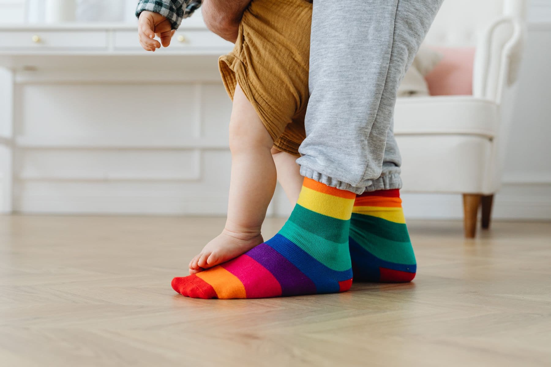 Parent and child sharing a playful moment in colorful socks